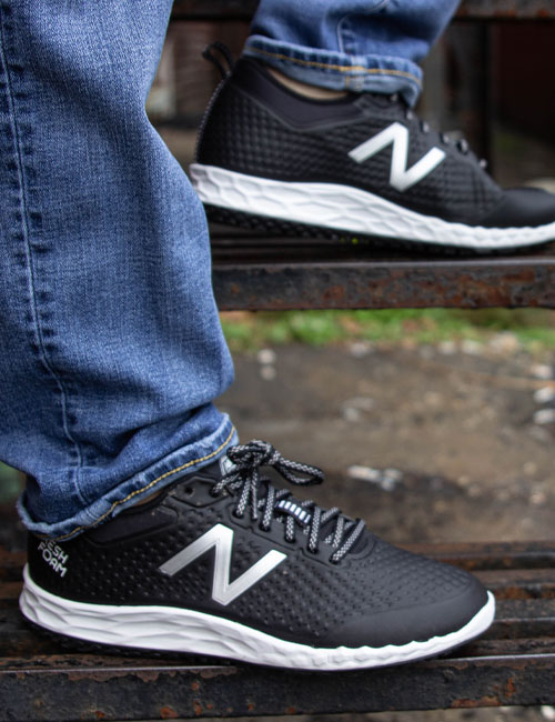 Person standing on stairs with New Balance Shoes